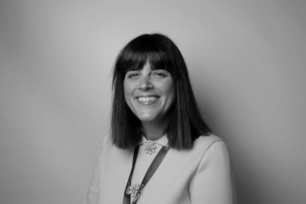 Lady with dark hair smiling at camera