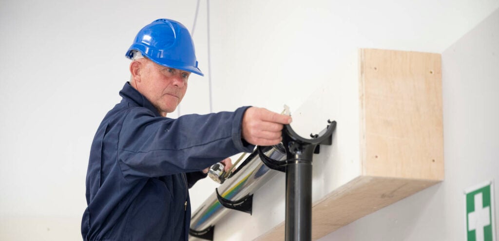 Adult learner working on guttering