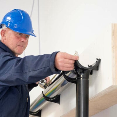 Adult learner working on guttering