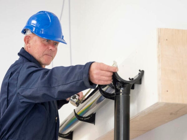 Adult learner working on guttering