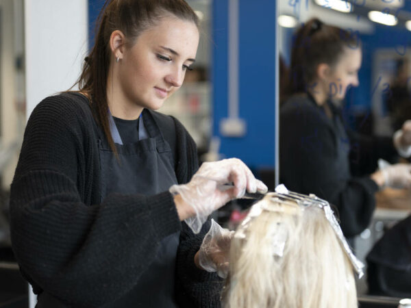 Hairdressing student working on a client