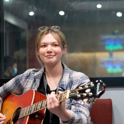 Music student playing a guitar