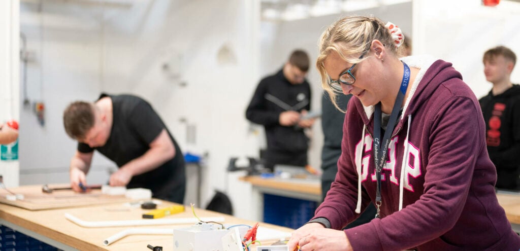 Electrical student working on a plug socket wiring