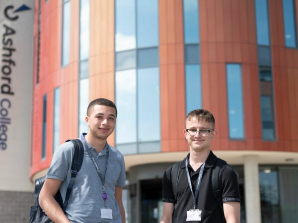 Students standing outside of the college doors