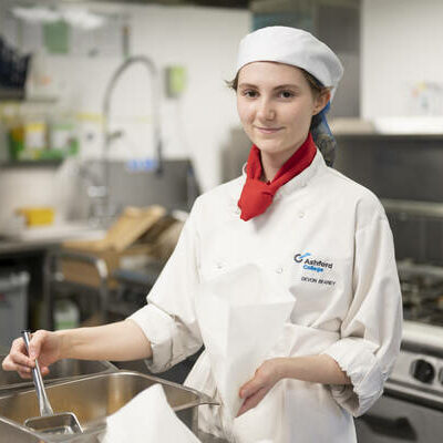 Catering student dishing up food