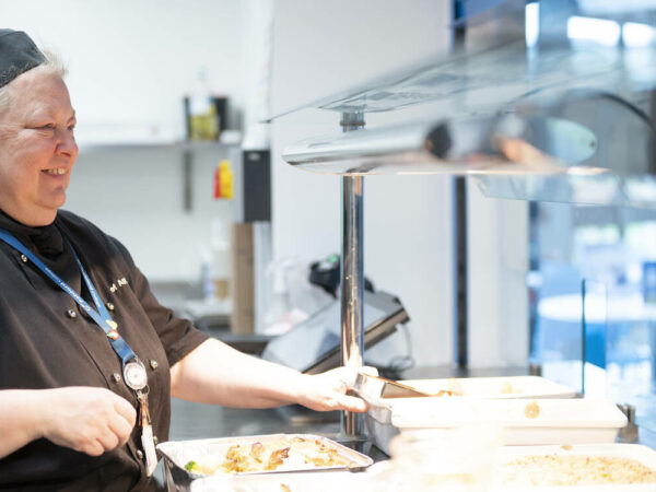 Catering staff memeber working with hot plates