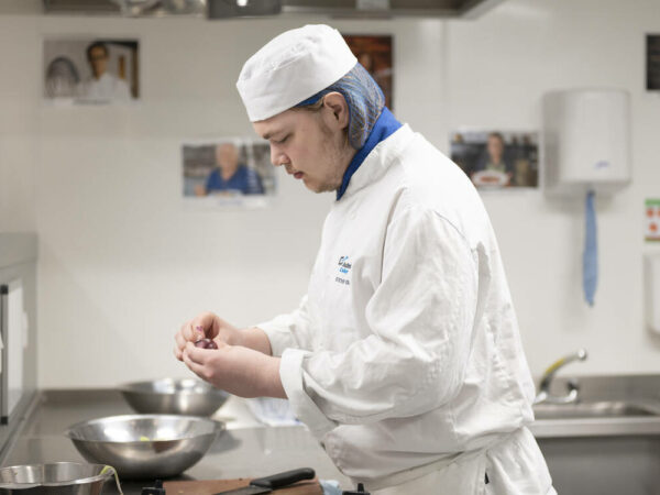 Catering student preparing food