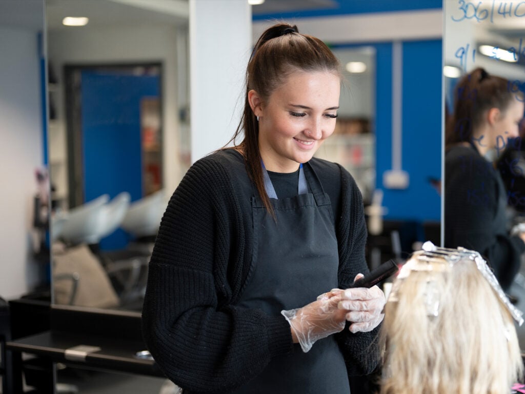 Hairdressing student working on a client