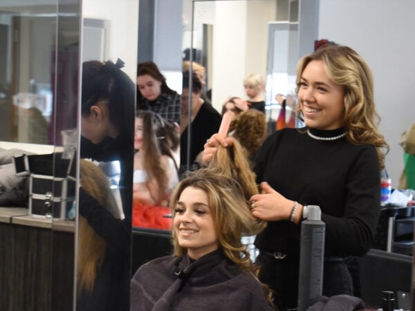 Hairdressing student working on a client