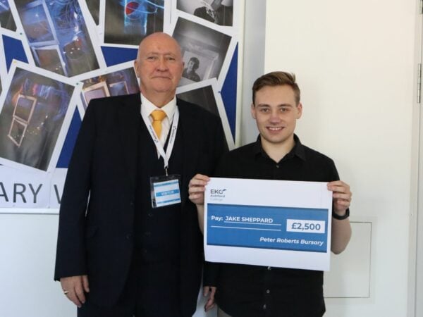 Peter Roberts Bursary Award winner, Jake, holding a cheque presented by Peter McCann, Chair for Quality and Safeguarding at the Skills Network
