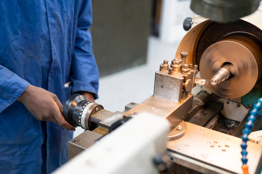 engineering student using workshop equipment