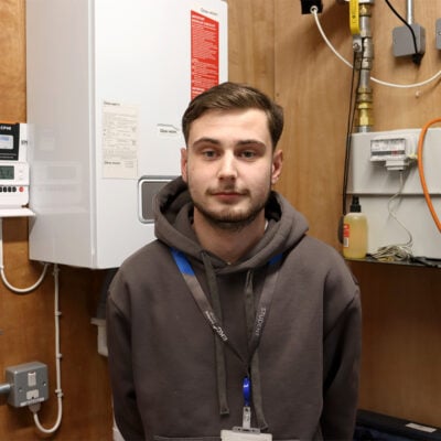 Man standing in front of a boiler