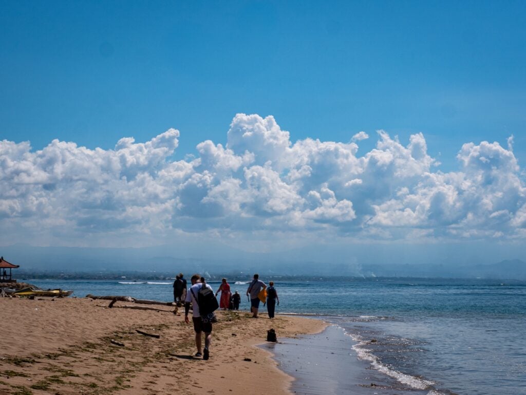 students walking on a beach in bali