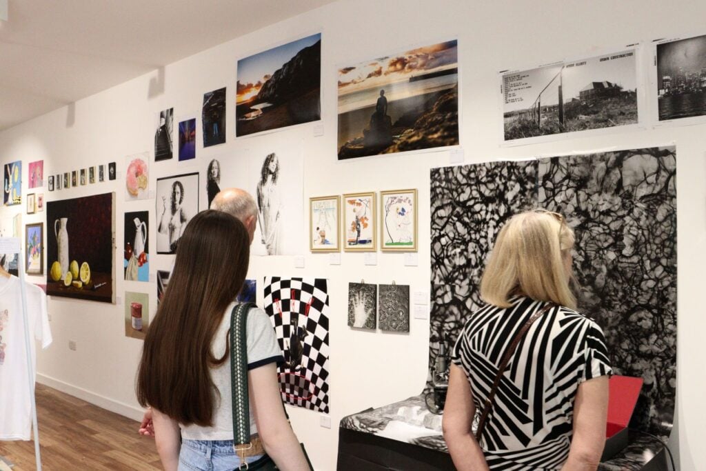 General public looking at art in gallery