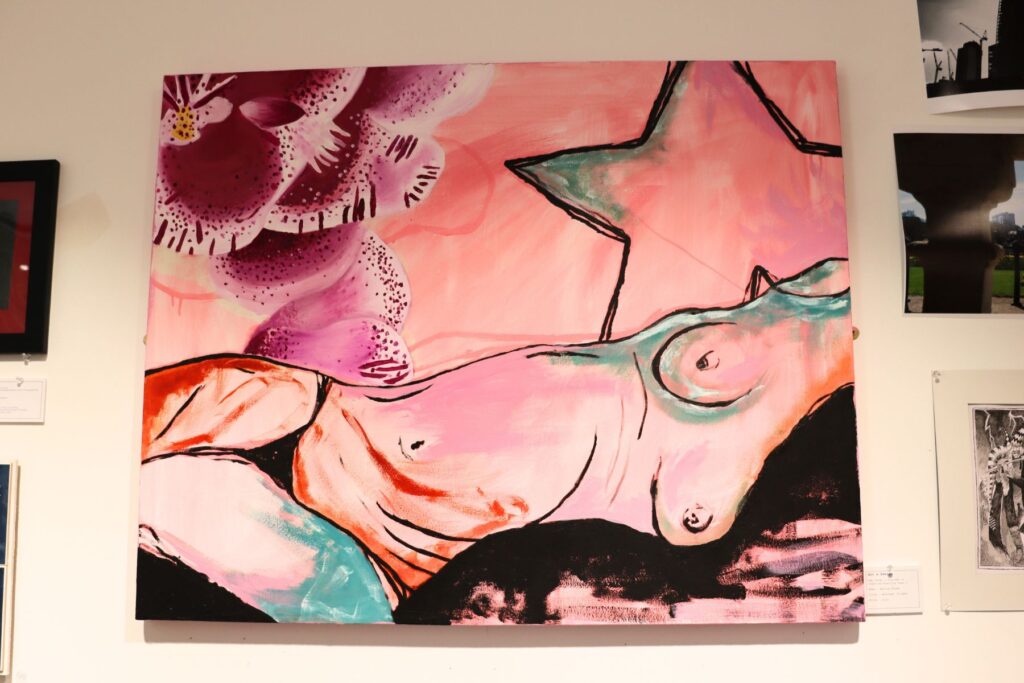 Pink painting of a nude female body with a orchid painted behind