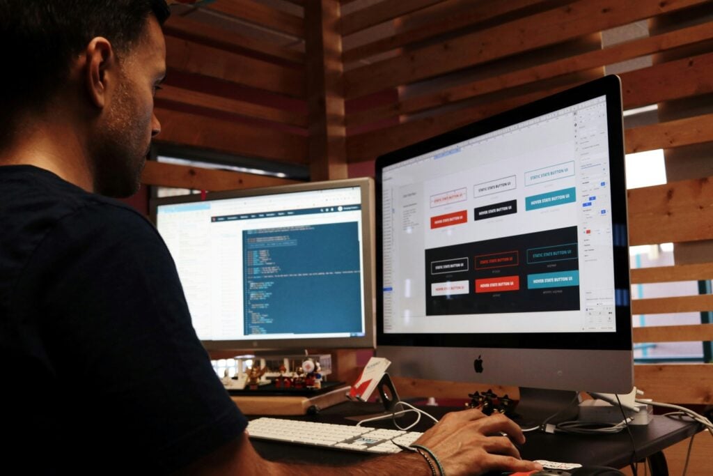 a student looking at dual computer screens