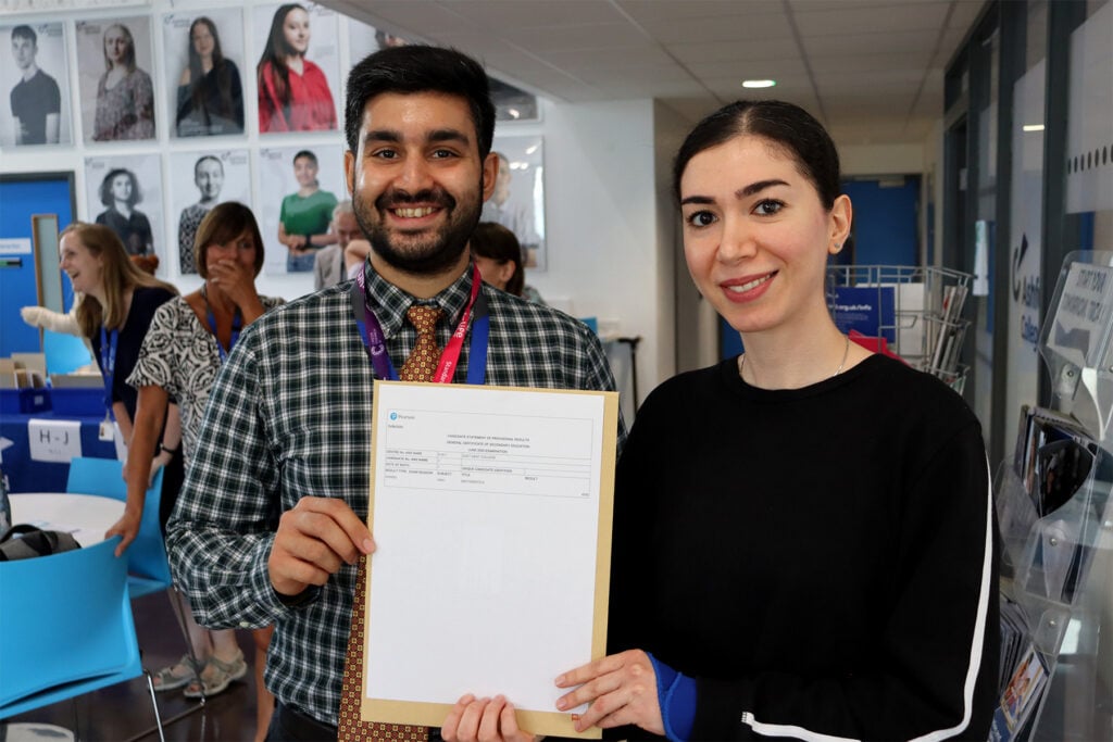Tutor and students holding certificate