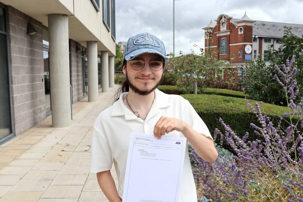 Young student holding exam certificate looking happy