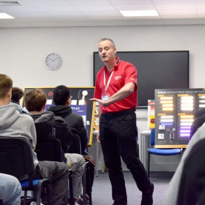 Visitor talking to the students about electrical careers.