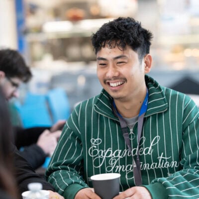 adult learner smiling and relaxing in break room