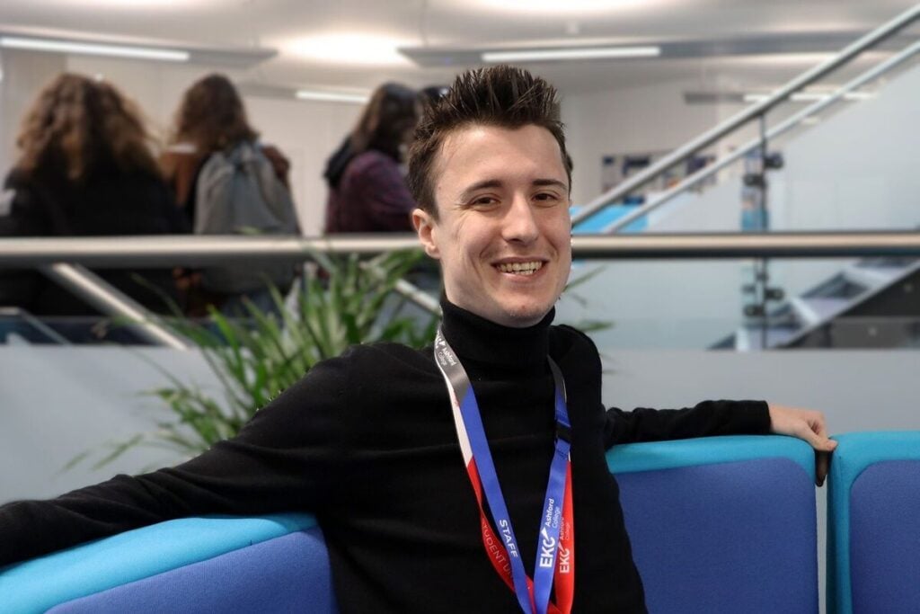 Student sat smiling at the camera