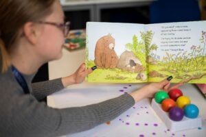 Woman reading a children's book