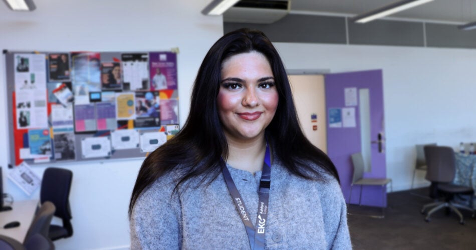 close up of student in a business classroom. she is smiling at the camera