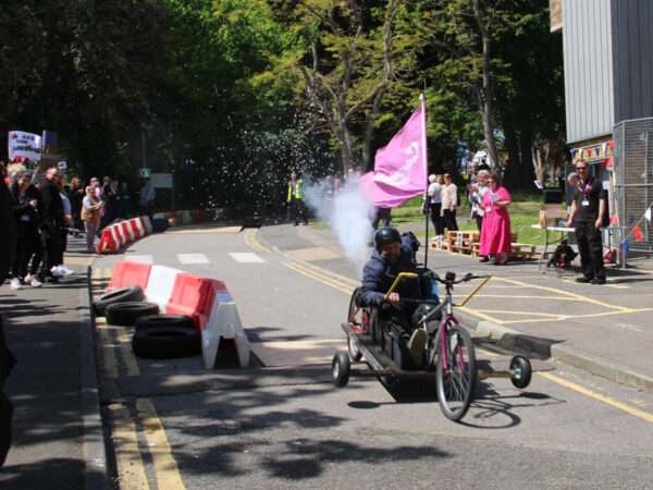 Go kart being driven on campus, built by students.