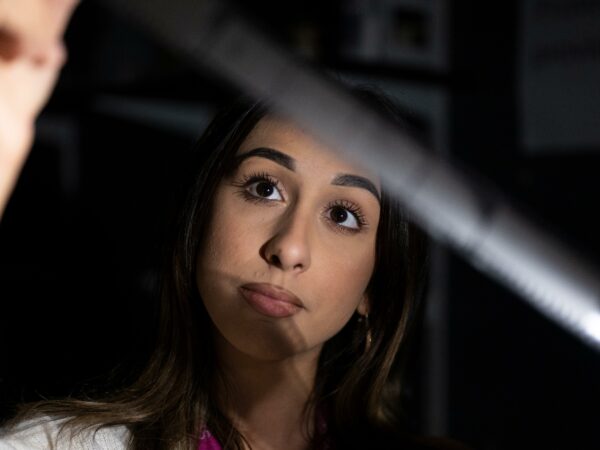 Student looking at photo negatives in the dark room