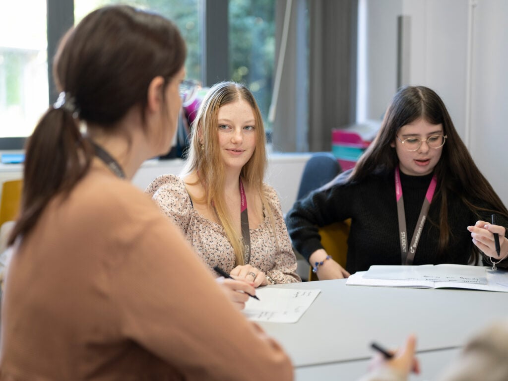 Students in a discussion with lecturer