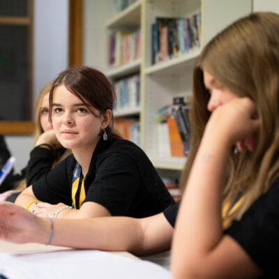 Junior College student listening to tutor