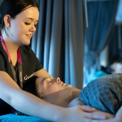 Beauty student giving client a massage