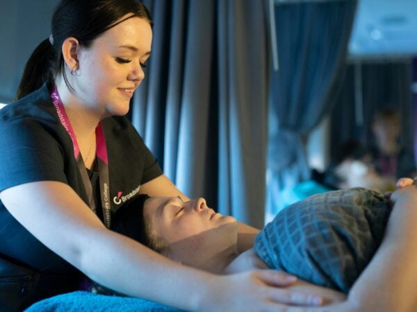 Beauty student giving client a massage