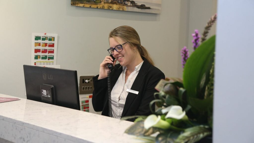 Business student working in hotel reception