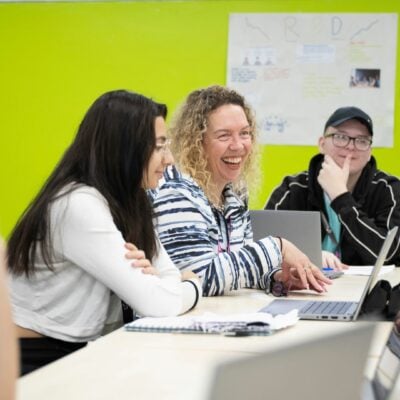 Business students and tutor in classroom