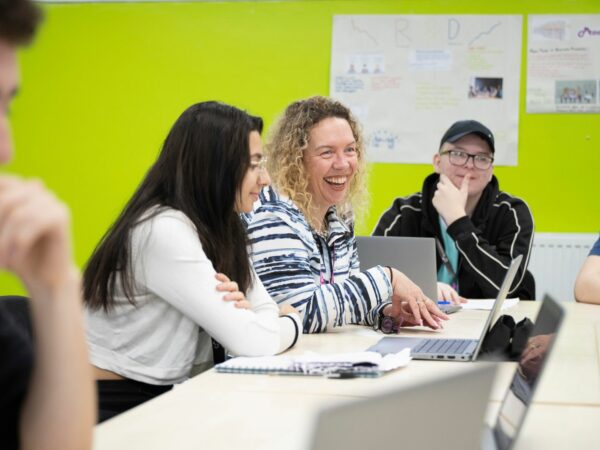 Business students and tutor in classroom