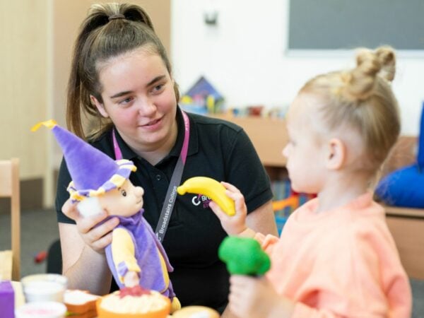 Early Years student working in nursery with child