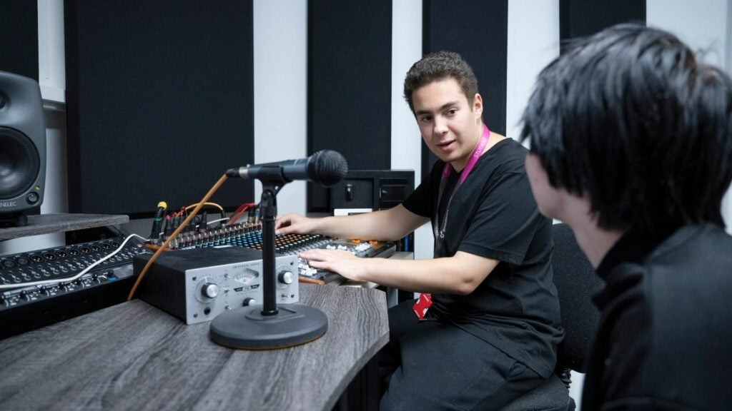 Music students mixing music in the recording studio