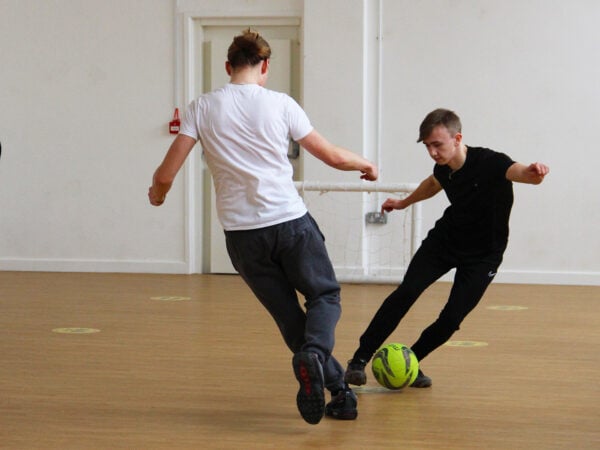 Sports students playing football in the sports hall at EKC Broadstairs College