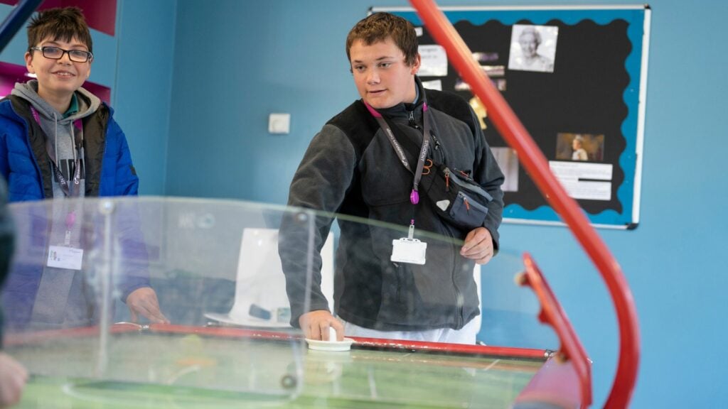 Students playing air hockey