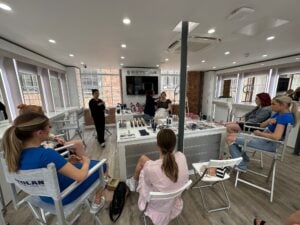 Students watch a masterclass tutorial by Kryolan professionals