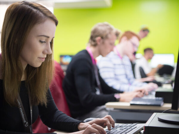 Computing student typing on a computer.