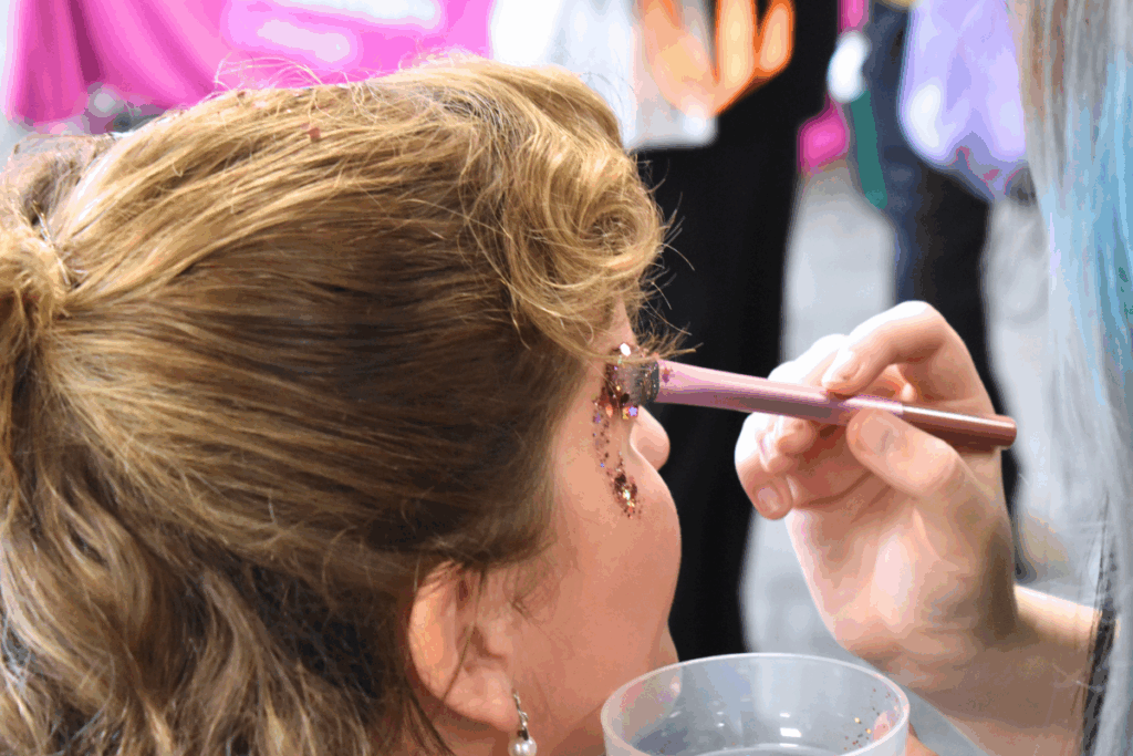 a female student having glitter painted onto her face
