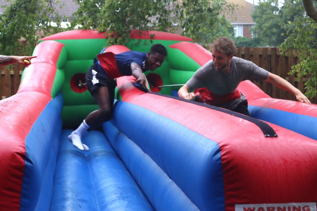 two students on inflatable game