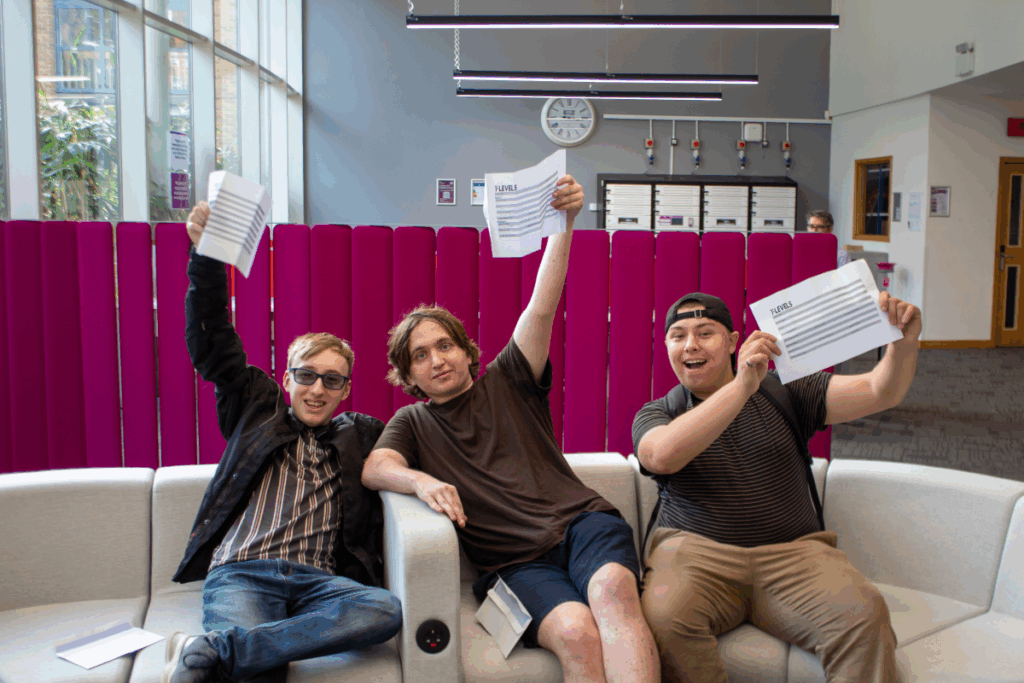 three business students show their t level results