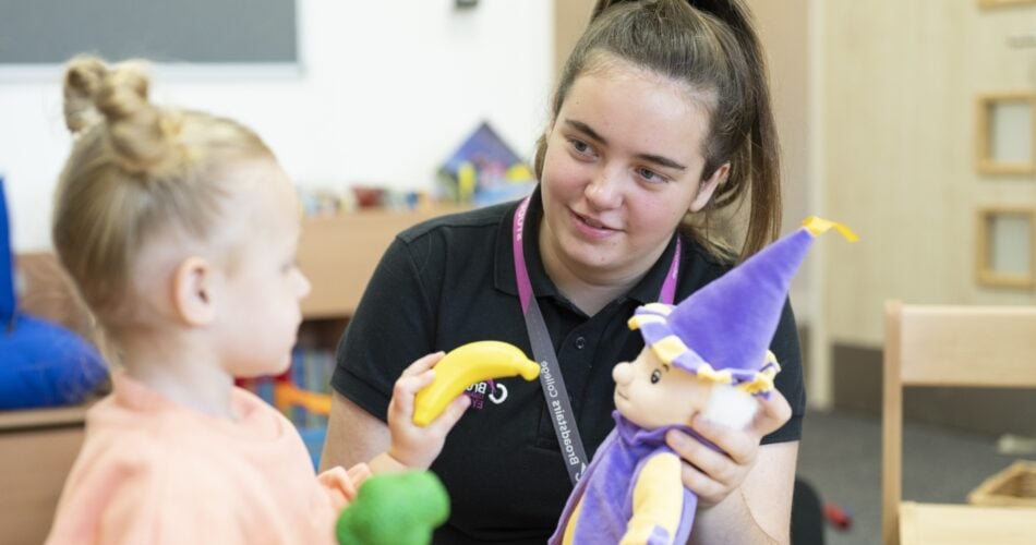 childcare college student interacts with child