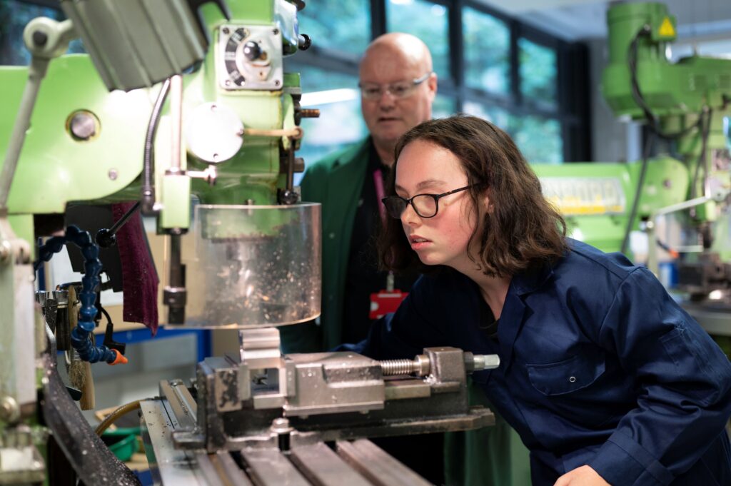 Student using a machine in the engineering lab