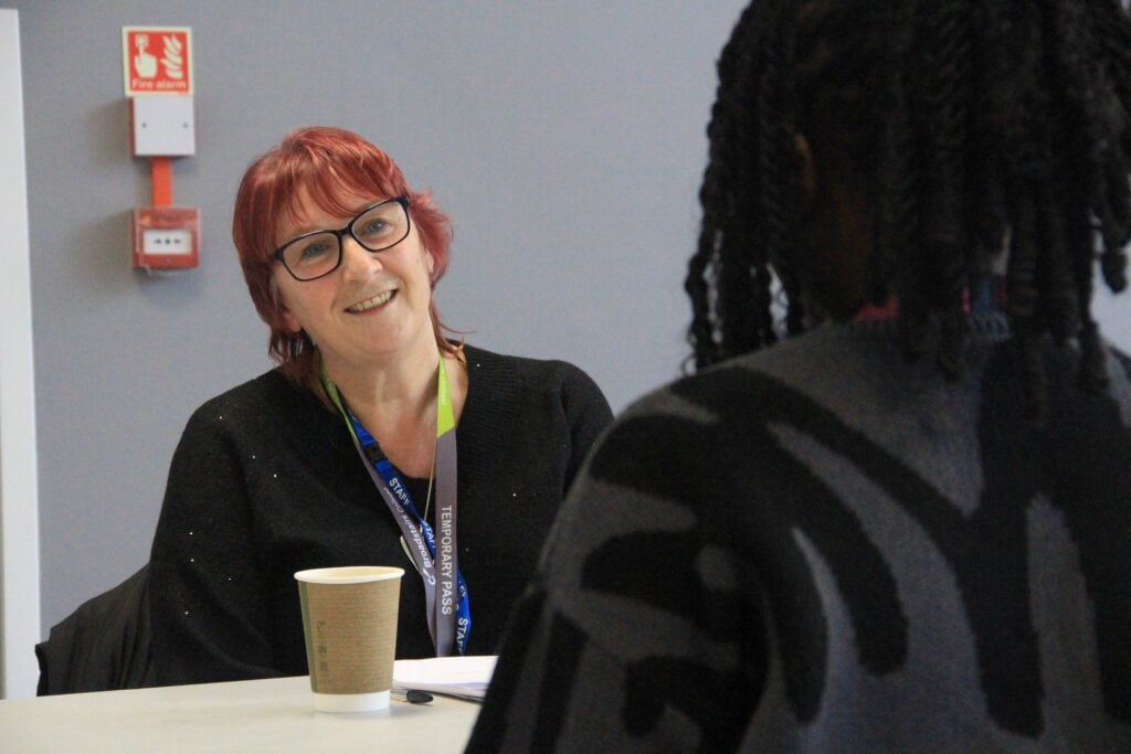 Interviewer (Karen) smiling at a student