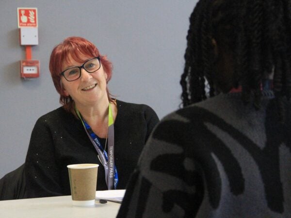 Interviewer (Karen) smiling at a student