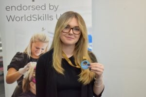 Student holding gold medal